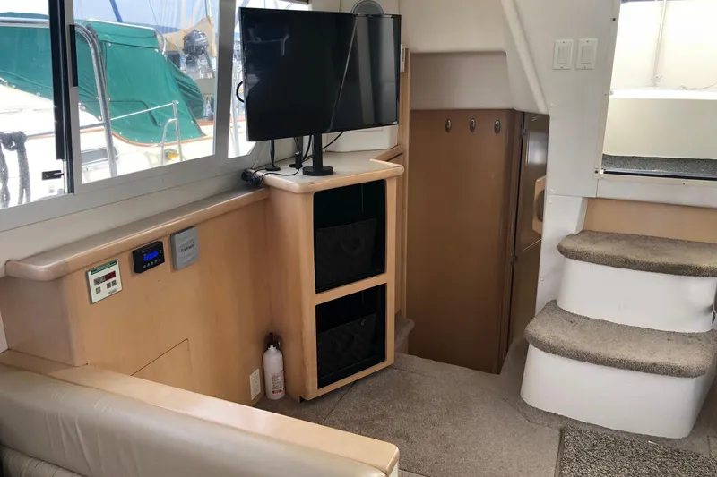 Slide: The Image of Interior of 1997 Carver 355 Aft Cabin Motor Yacht with TV and stairs. - 28