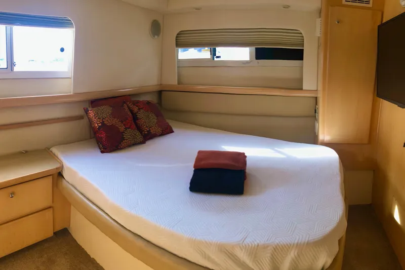 Slide: The Image of Cozy bedroom in 1997 Carver 355 Aft Cabin Motor Yacht with pillows and folded towels. - 29