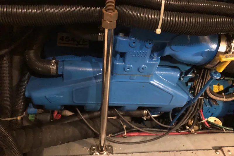 Slide: The Image of Engine compartment of 1997 Carver 355 Aft Cabin Motor Yacht, featuring blue engine components. - 8