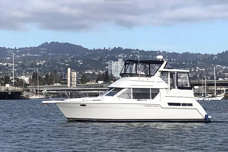 The Image of 1997 Carver 355 Aft Cabin Motor Yacht on water with scenic background. - 0
