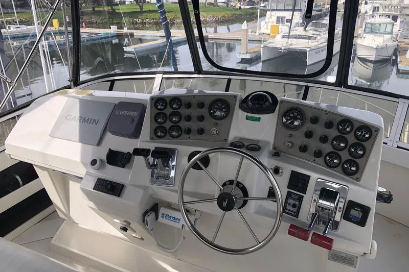 Slide: The Image of 1997 Carver 355 Aft Cabin Motor Yacht helm with Garmin navigation system and control panel. - 14