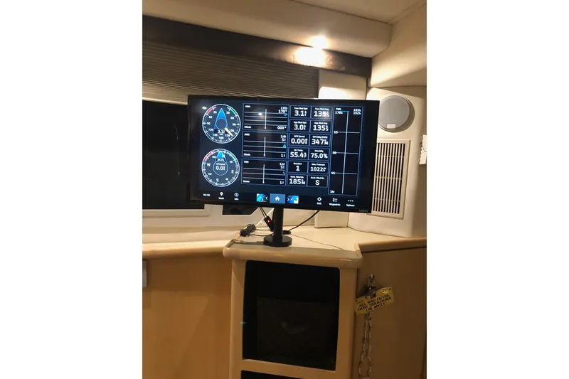 Slide: The Image of 1997 Carver 355 Aft Cabin Motor Yacht interior with navigation display screen. - 16