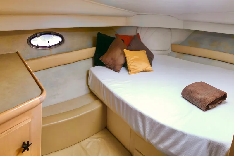 Slide: The Image of 1997 Carver 355 Aft Cabin Motor Yacht bedroom with cozy bed and porthole window. - 20