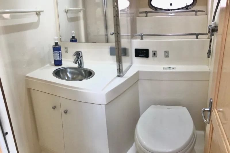 Slide: The Image of 1997 Carver 355 Aft Cabin Motor Yacht bathroom with sink, toilet, and mirror. - 21