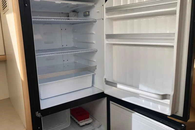 Slide: The Image of Empty refrigerator inside a 1997 Carver 355 Aft Cabin Motor Yacht. - 24