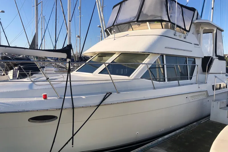 Slide: The Image of 1997 Carver 355 Aft Cabin Motor Yacht docked at marina, side view. - 3