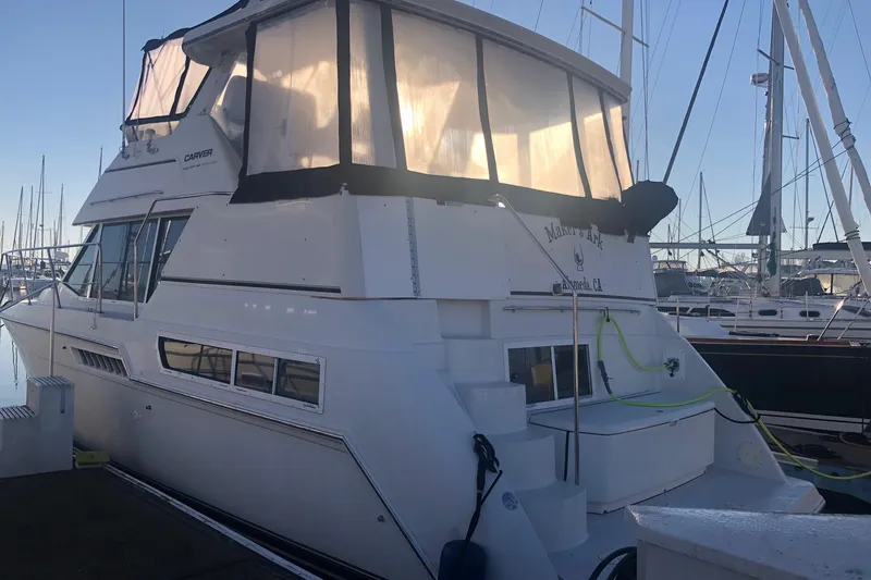 Slide: The Image of 1997 Carver 355 Aft Cabin Motor Yacht docked at marina, side view. - 6