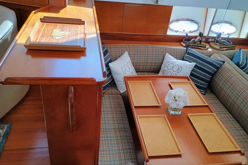 Slide: The Image of Luxurious 1988 Vantare 46' yacht interior with cozy seating and elegant wooden table. - 15