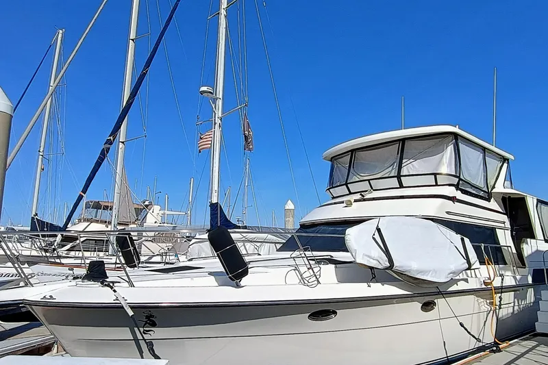 Slide: The Image of 1988 Vantare 46' Aft Cabin Wide Body MY yacht docked at marina. - 2