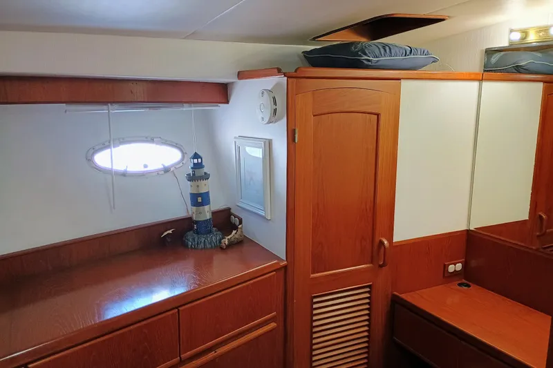 Slide: The Image of 1988 Vantare 46' Aft Cabin interior with wooden cabinetry and nautical decor. - 28