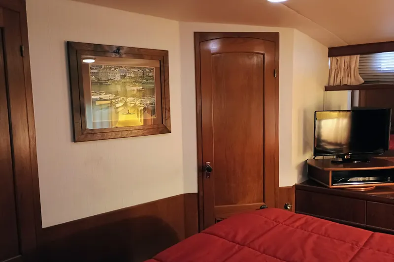 Slide: The Image of Interior of 1988 Vantare 46' Aft Cabin Wide Body MY with wood paneling and TV. - 37