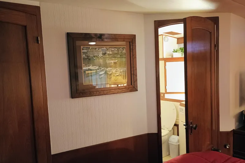 Slide: The Image of Interior of 1988 Vantare 46' Aft Cabin Wide Body MY with wooden doors and framed artwork. - 38