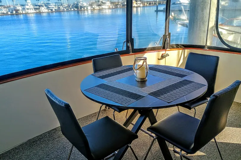 Slide: The Image of Dining area on 1988 Vantare 46' Aft Cabin Wide Body MY with marina view. - 40