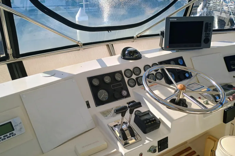 Slide: The Image of 1988 Vantare 46' Aft Cabin yacht helm with steering wheel and navigation controls. - 43