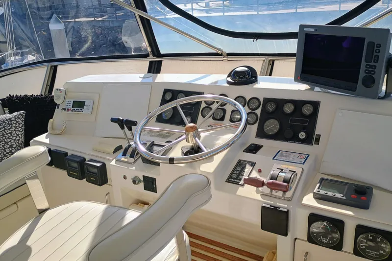 Slide: The Image of 1988 Vantare 46' Aft Cabin Wide Body MY helm with steering wheel and navigation equipment. - 44