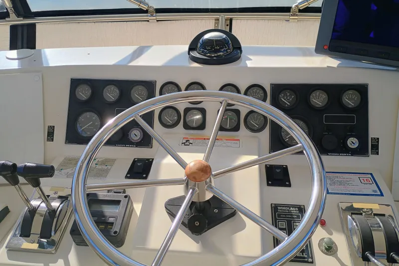 Slide: The Image of Helm of 1988 Vantare 46' Aft Cabin Wide Body MY with steering wheel and navigation instruments. - 45