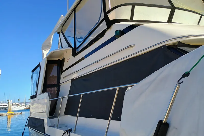 Slide: The Image of 1988 Vantare 46' Aft Cabin Wide Body MY yacht docked under clear blue sky. - 59