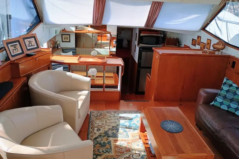 Slide: The Image of Luxurious interior of 1988 Vantare 46' Aft Cabin Wide Body MY yacht, featuring elegant seating and decor. - 6