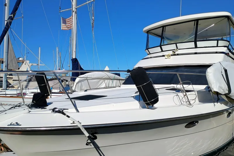 Slide: The Image of 1988 Vantare 46' Aft Cabin Wide Body MY yacht docked under clear blue sky. - 63