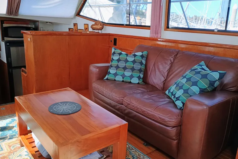 Slide: The Image of Interior of 1988 Vantare 46' yacht with leather sofa and wooden table. - 7
