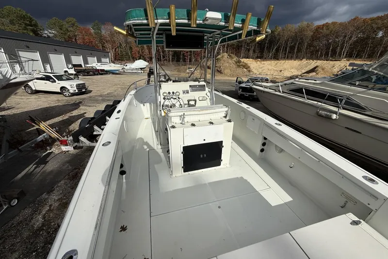 Slide: The Image of 1997 Stamas 270 Tarpon boat with center console, docked outdoors under cloudy skies. - 4