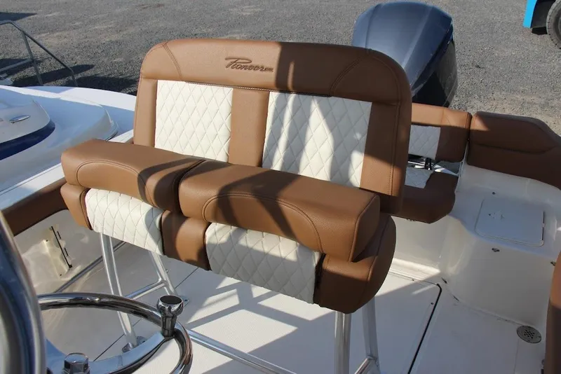 Slide: The Image of 2025 Pioneer 222 Islander boat with brown and white cushioned seating. - 4
