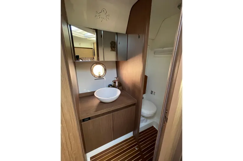Slide: The Image of Bathroom interior of 2018 Benetau Gran Turismo 40 yacht with modern sink and porthole. - 12