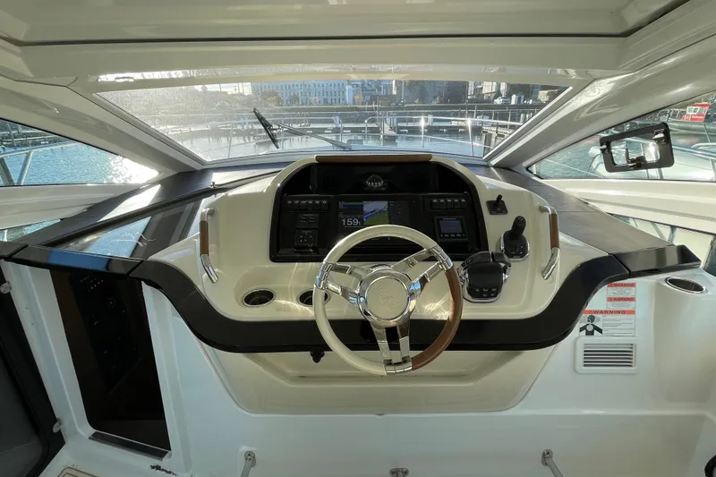 Slide: The Image of 2018 Benetau Gran Turismo 40 yacht helm with modern controls and steering wheel. - 16
