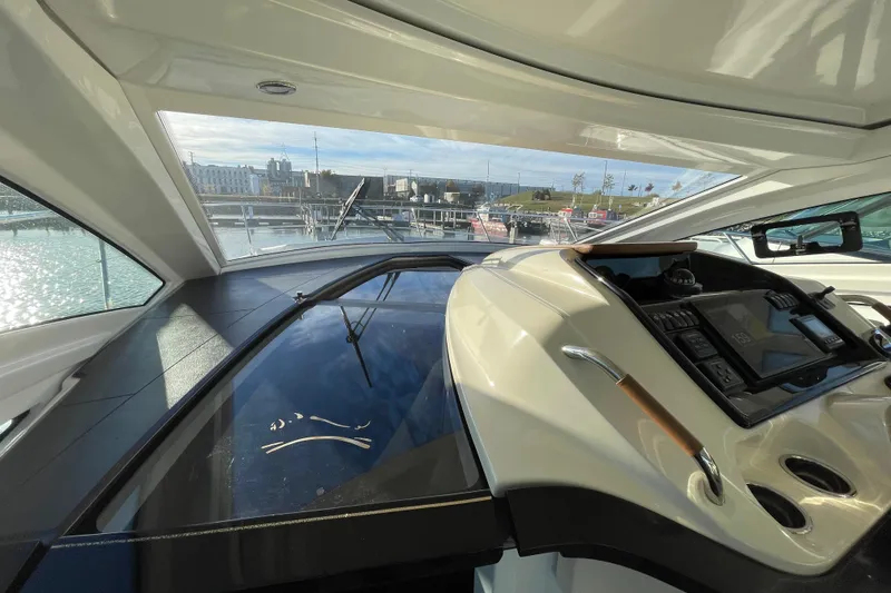 Slide: The Image of 2018 Benetau Gran Turismo 40 yacht interior with modern dashboard and marina view. - 20