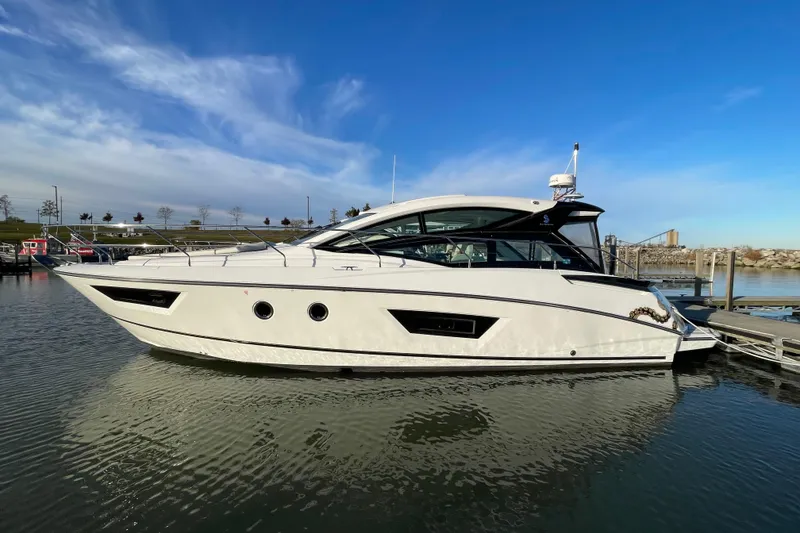 Slide: The Image of 2018 Benetau Gran Turismo 40 yacht docked in a serene marina setting. - 3