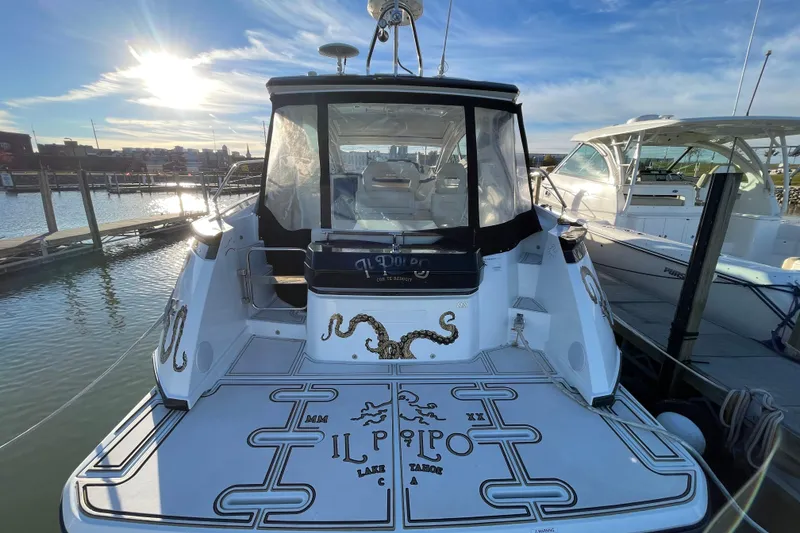 Slide: The Image of 2018 Benetau Gran Turismo 40 yacht docked at marina, rear view with custom graphics. - 4