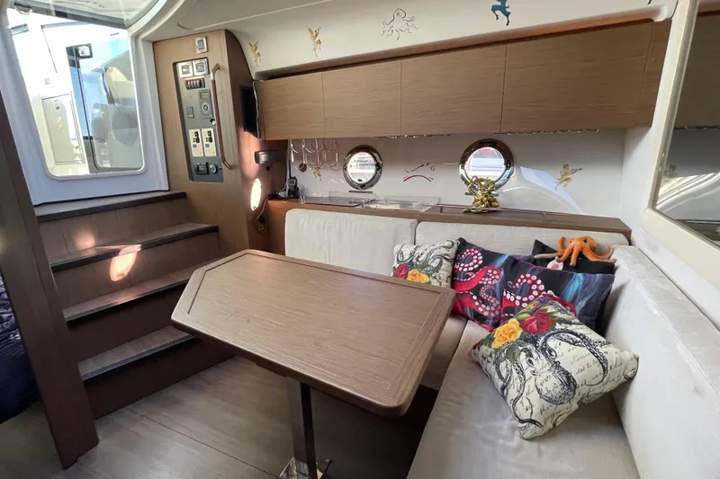 Slide: The Image of 2018 Benetau Gran Turismo 40 interior with cozy seating and nautical-themed decor. - 6
