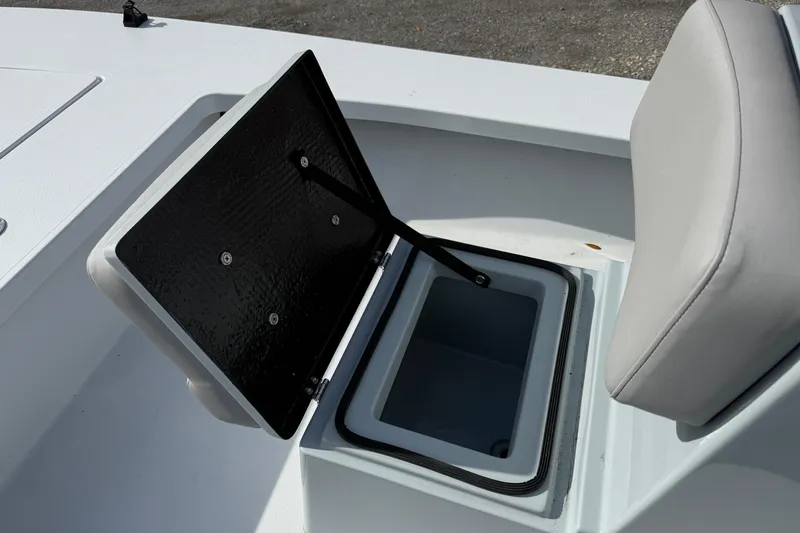 Slide: The Image of 2025 East Cape Vantage boat storage compartment with open lid and cushioned seat. - 1