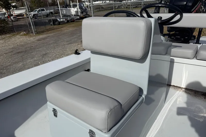 Slide: The Image of 2025 East Cape Vantage boat seat with gray cushions, steering wheel visible in background. - 2