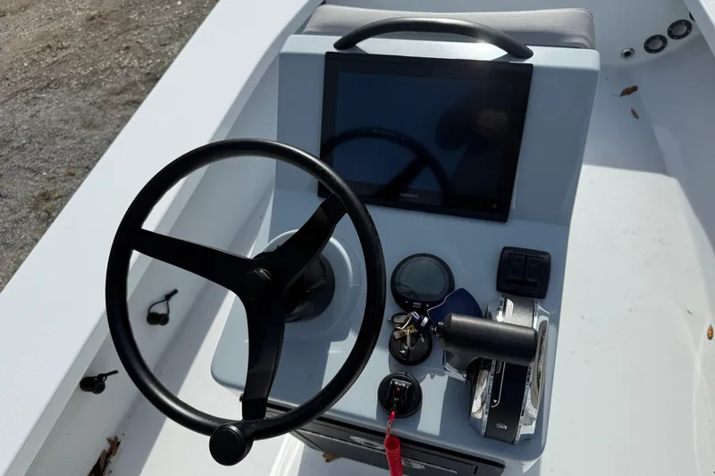 Slide: The Image of 2025 East Cape Vantage boat console with steering wheel and navigation display. - 3