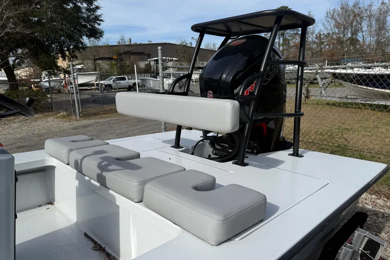 Slide: The Image of 2025 East Cape Vantage boat with cushioned seating and powerful outboard motor. - 5