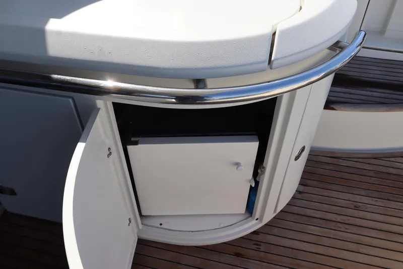 Slide: The Image of Open cabinet on 2007 Azimut 62S yacht with wooden deck and stainless steel railing. - 13