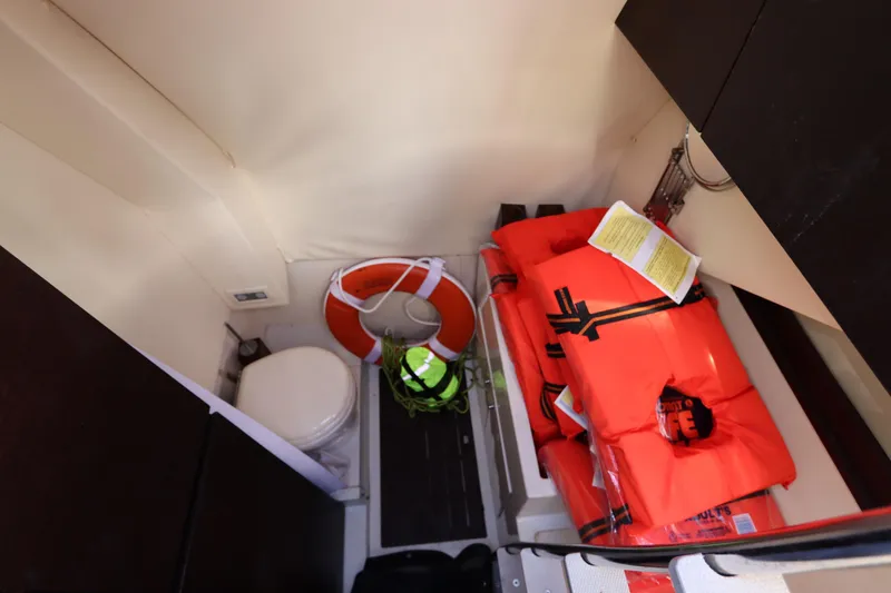 Slide: The Image of Storage area in a 2007 Azimut 62S yacht with life jackets and a life preserver. - 17