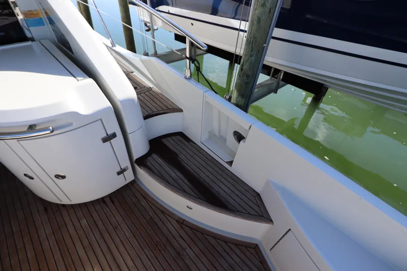 Slide: The Image of 2007 Azimut 62S yacht with elegant wooden steps and sleek white cabinetry. - 20