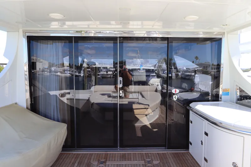 Slide: The Image of 2007 Azimut 62S yacht interior with glass doors and luxurious seating area. - 26