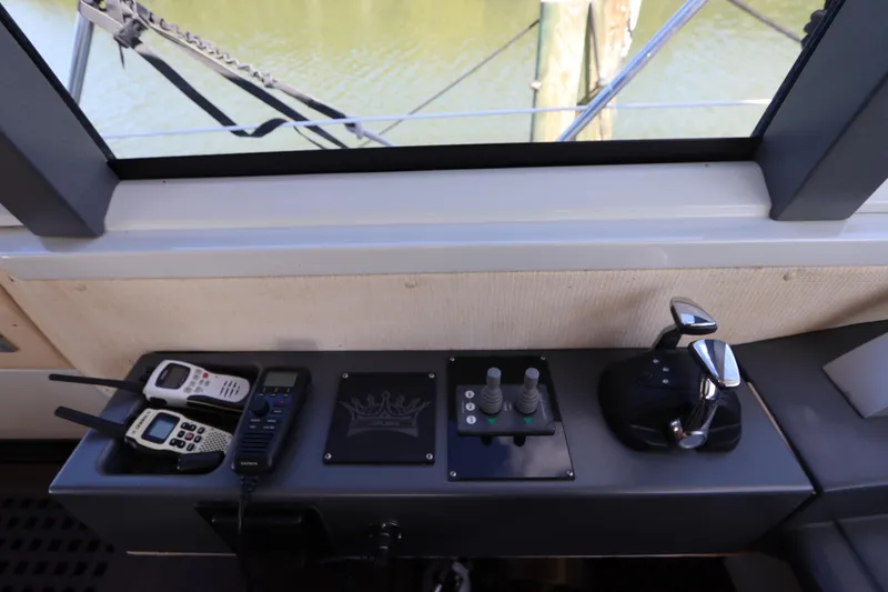 Slide: The Image of Control panel of a 2007 Azimut 62S yacht with communication devices and throttle controls. - 37