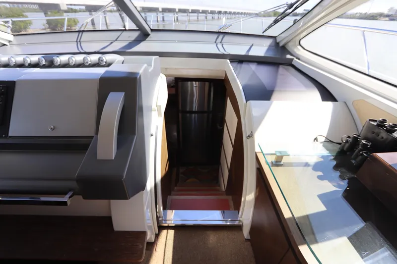 Slide: The Image of 2007 Azimut 62S yacht interior with helm, stairs, and navigation equipment. - 39
