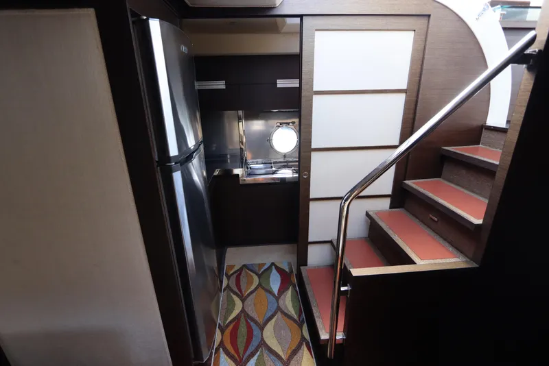 Slide: The Image of Modern kitchen area in 2007 Azimut 62S yacht with stairs and stainless steel appliances. - 44