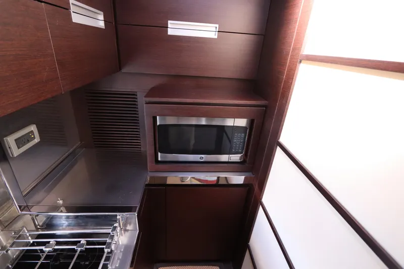 Slide: The Image of Luxurious kitchen area in a 2007 Azimut 62S yacht with microwave and stove. - 49