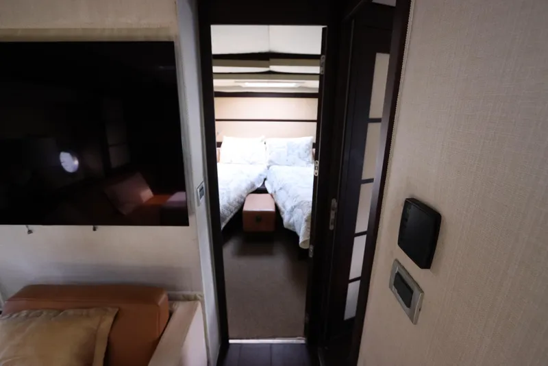 Slide: The Image of Interior of 2007 Azimut 62S yacht showing a cozy bedroom and modern design. - 51