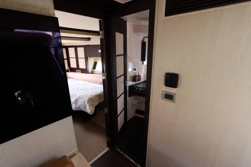 Slide: The Image of Interior of 2007 Azimut 62S yacht showing bedroom and bathroom entrance. - 58