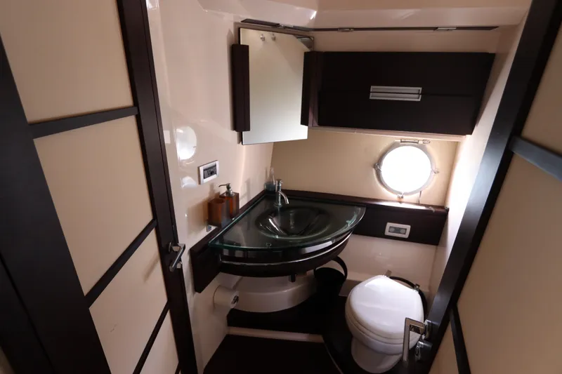 Slide: The Image of Luxurious bathroom in 2007 Azimut 62S yacht with modern fixtures and porthole window. - 60