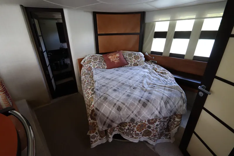 Slide: The Image of Luxurious bedroom interior of 2007 Azimut 62S yacht with cozy bedding and modern design. - 62