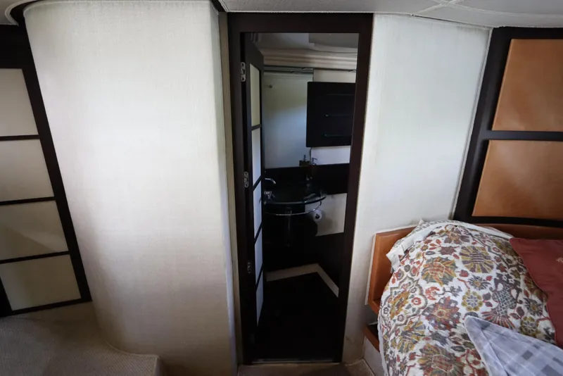 Slide: The Image of Interior of 2007 Azimut 62S yacht showing bedroom and bathroom entrance. - 66