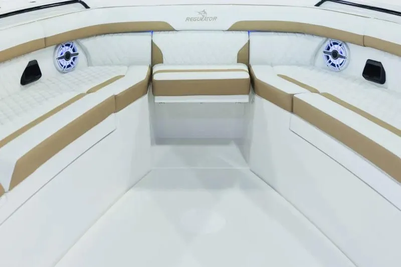 Slide: The Image of Manufacturer Provided Image: Luxurious interior of 2026 Regulator 35 boat with cushioned seating and speakers. - 2